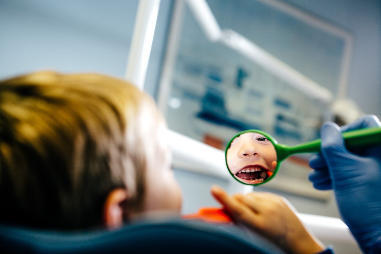 Friendly dentist with a young patient at Castelnau Dentists in Barnes