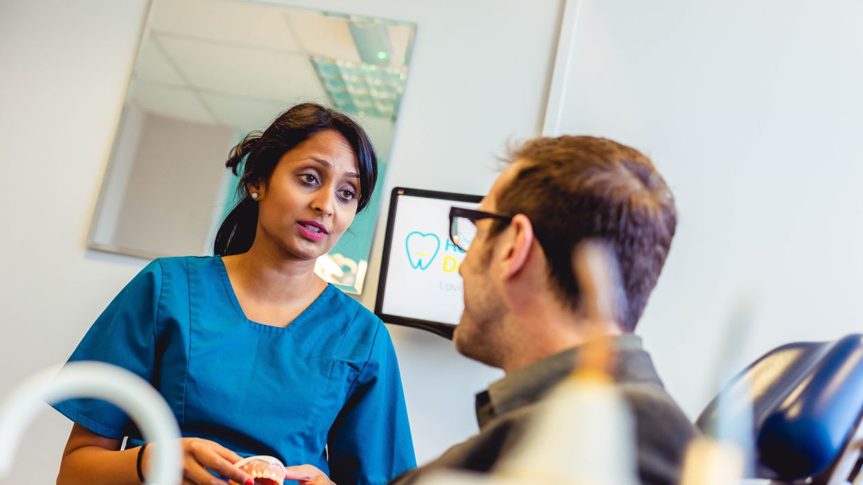 Dentist discussing composite bonding treatment with a patient at Castelnau Dentists