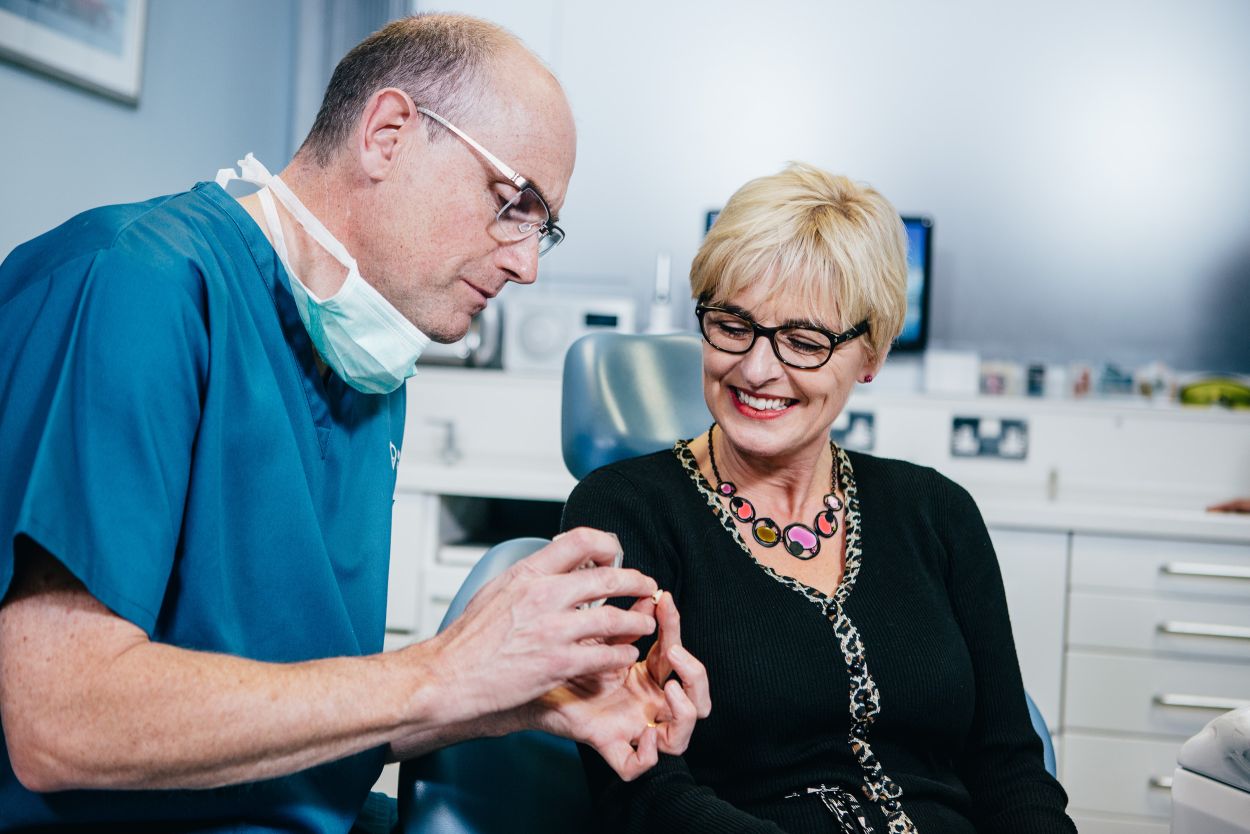 Dentist consulting with a patient about dental implant treatment at Castelnau Dentists